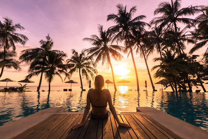 Man chilling on the beach hopping Live to be 100 yrears